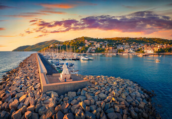 Colorful summer sunset on Agropoli port with a lots of yachts and stone pier, Italy, Europe. Spectacular evening seascape of Mediterranean sea. Traveling concept background.