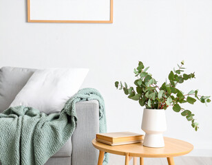 Cozy Interior Decor: A serene living space is showcased with a light gray sofa adorned with a textured aqua throw blanket.