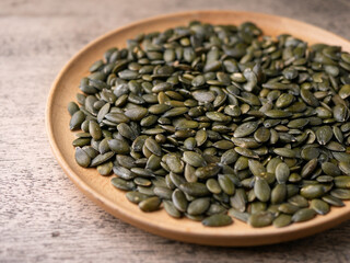 Peeled dry pepita pumpkin seeds background.