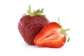 A close-up of a fresh, ripe strawberry, with a sliced section, on white.