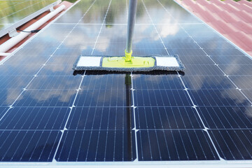 Cleaning solar panels to improve energy efficiency on a sunny day.