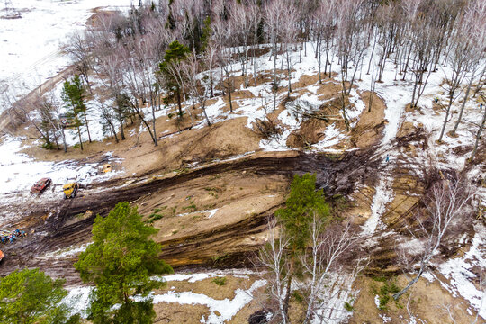 Tree felling for a clearing for laying power lines, aerial view in winter - Powered by Adobe