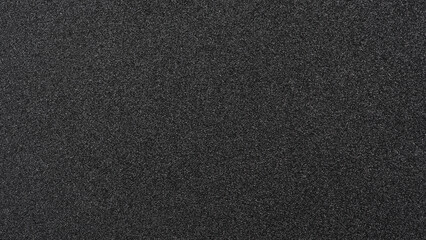 Shiny wrapper paper. black sandpaper texture background. 
