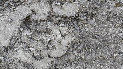 Rough concrete stone surface with grunge cracks and worn textures, natural wall background ideal for old building themes, rock patterns, and retro architectural visual content.