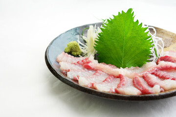Fermented Skate Sashimi with Garnish on Plate