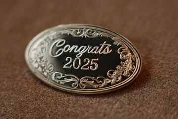 Elegant swirl script inside oval badge "Congrats 2025"