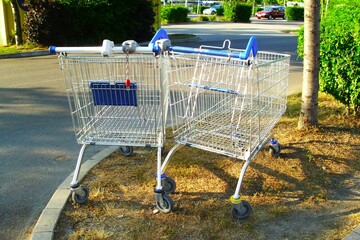 Two shopping carts left outside in the parking lot.