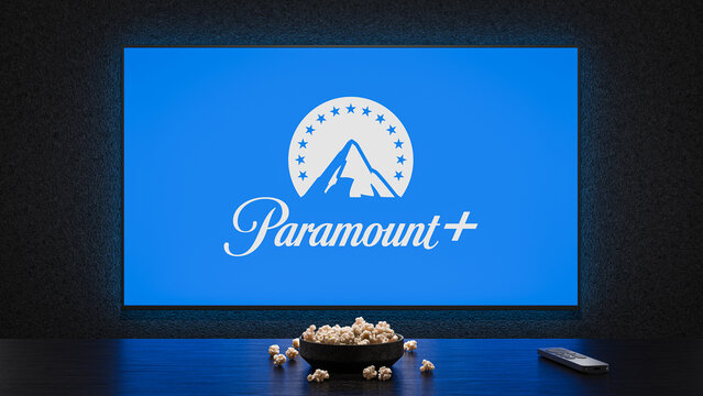 A TV showing the logo splash screen of Paramount+, with a bowl of popcorn and TV remote in the foreground