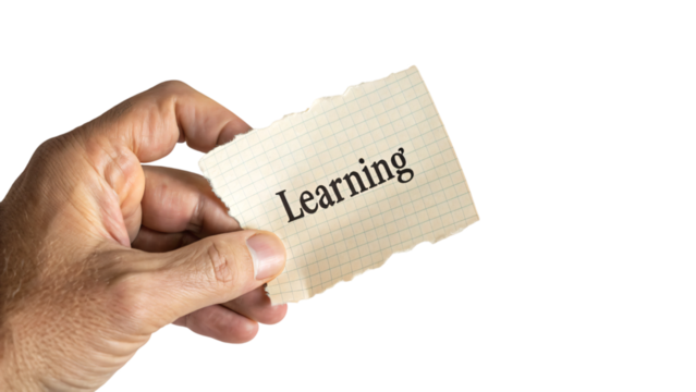 Hand holding a paper with learning word for education