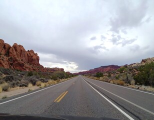 Naklejka premium Empty highway through red rock landscape