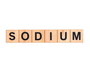 Wooden letter tiles spell out the word "SODIUM" in uppercase black font, arranged in a single line.