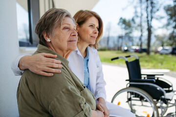 Female doctor spending time with resident of nursing home.