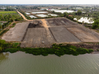 Land development progress near river rural area aerial view construction environmental impact