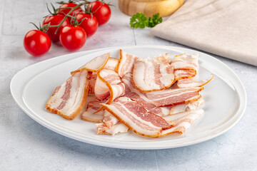 Raw pork tenferloin with bacon