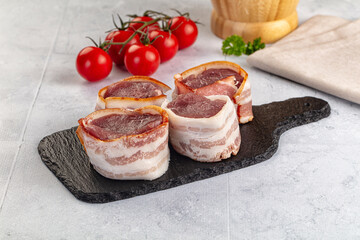 Raw pork tenferloin with bacon