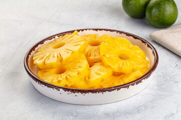 Sweet canned pineapple slices in syrope