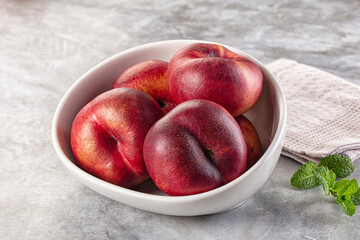 Ripe sweet juicy flat nectarines heap
