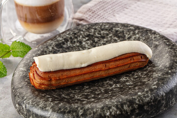 White vanilla eclair with icing