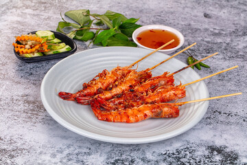 Grilled prawn skewer served sauce