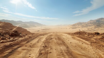 A remote sandy track stretches into the horizon, surrounded by stunning desert landscape and mountains under a bright blue sky. Perfect for adventure and exploration themes.