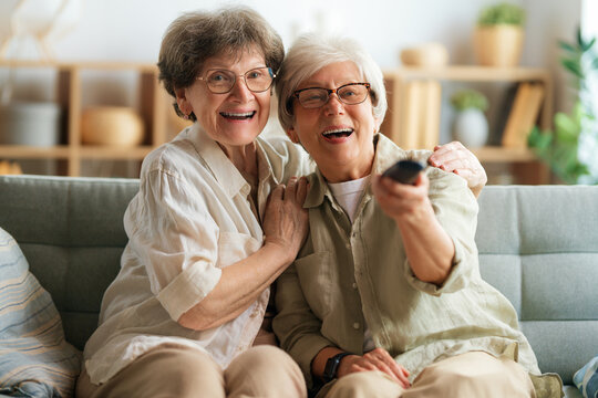 Senior women watching TV - Powered by Adobe