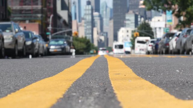 New York City skyline, Manhattan Midtown cityscape. High-rise skyscrapers from Queens, Long Island, Hunters Point, USA. Cars on street, yellow dividing line, road marking. United States architecture.
