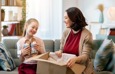 Mother and daughter are unpacking cardboard
