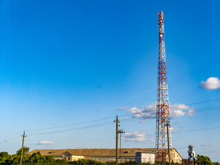 A cell phone tower in the middle of a field