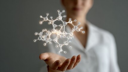 A person holds a glowing molecular structure, symbolizing innovation in science.