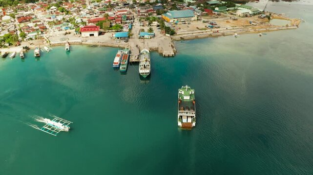 Passenger port with ferries and cargo ships on the island of Siargao,aerial view. Dapa Ferry Terminal. Siargao, Philippines.