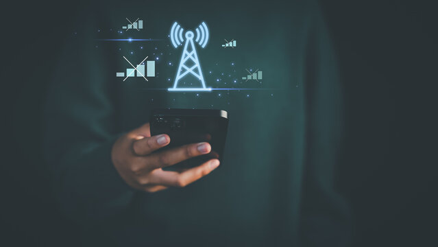 The mobile network is not working. Hand holding a smartphone with glowing signal tower and disconnected icons, illustrating network issues, weak signal, or no connection concept.