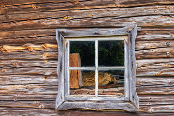 Window on an old barn built with wooden logs © Lars Johansson