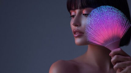 Portrait of a woman holding a colorful lighted fan, showcasing beauty and elegance.