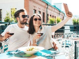 Smiling beautiful woman and her handsome boyfriend. Happy cheerful family. Couple cheering with...