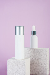 Plastic white tube for cream or lotion. Skin care or sunscreen cosmetic with stylish props on purple background.