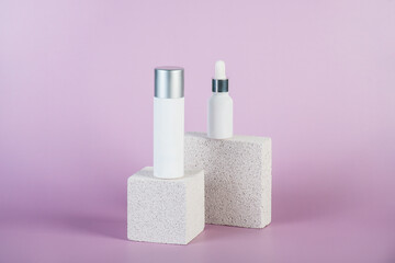 Plastic white tube for cream or lotion. Skin care or sunscreen cosmetic with stylish props on purple background.