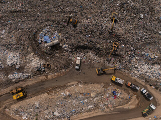Trucks are collecting waste in large piles for disposal and recycling.