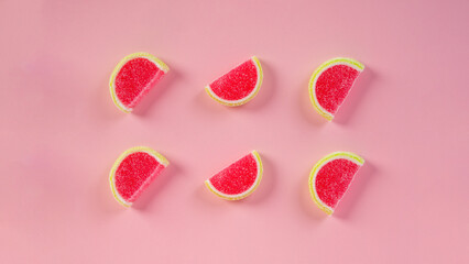 Fruit jelly mixed with sugar on pink background