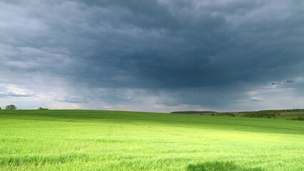 A Dramatic and Beautiful Cloudy Sky Over Lush Green Fields Creates a Captivating Scene Time lapse.