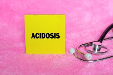 Acidosis writing concept on sticky note isolated on pink background. stethoscope as decoration.
