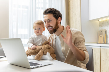 Young bearded man having a video call and holding his little son