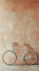 Fototapeta premium Vintage cream bicycle against textured wall