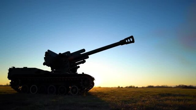 A howitzer cannon positioned on rocky terrain unleashes a massive shell during sunrise, shaking the ground as debris and light scatter outward