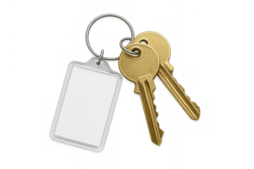 Golden keys linked on metal ring with blank white tag, suspended against transparent backdrop, waiting for personalized messaging
