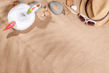 A tropical summer background featuring soft beach sand with delicate palm leaf shadows and sunhat