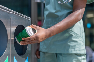 Close up picture of a woman throwing waste to the sorting waste bin