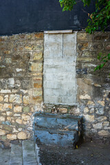Bricked Doorway with Concrete Steps. Stone wall Background.
