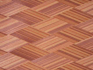 Interwoven mahogany strips reveal a rich tapestry of burnt sienna and copper, artfully aligned in a herringbone allure