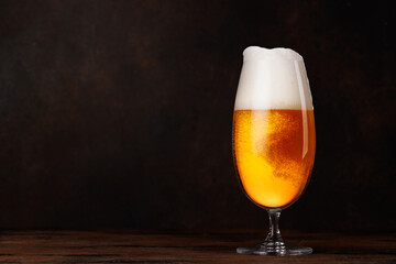 A glass of beer with a golden hue and frothy head