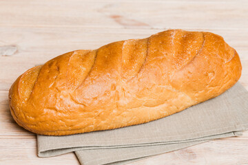 Assortment of freshly baked bread with napkin on rustic table top view. Healthy unleavened bread. French bread